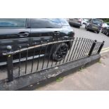 A SET OF CAST IRON RAILINGS, with arched top, posts are 61cm high, max height 70cm in six 242cm
