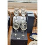 A SET OF SIX CRYSTAL WINE GLASSES, and a pair of tall crystal glasses all with WHGC logo etched on