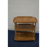 AN ERCOL GOLDEN DAWN THREE TIER TEA TROLLEY, united by cylindrical supports, on orbit casters, width