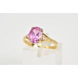 AN 18CT GOLD SAPPHIRE RING, designed with a single claw set oval cut pink sapphire to the