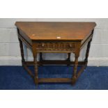 A REPRODUCTION OAK HALL TABLE, canted front corners with a single drawer, and drop leaf to the rear,