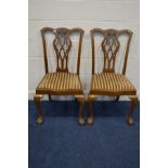 A PAIR OF LATE 19TH CENTURY WALNUT CHIPPENDALE STYLE DINING CHAIRS with stripped drop in seat pads