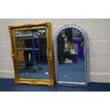 A MODERN GILT FRAMED MIRROR with ornate detail to frame and bevelled glass 65cm wide x 94cm high and