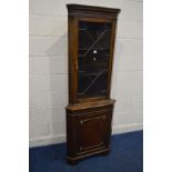 A REPRODUCTION MAHOGANY GLAZED SINGLE DOOR CORNER CUPBOARD (key)