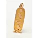 AN EGYPTIAN YELLOW GOLD INGOT PENDANT, with hieroglyphic detail to the front of the engraved