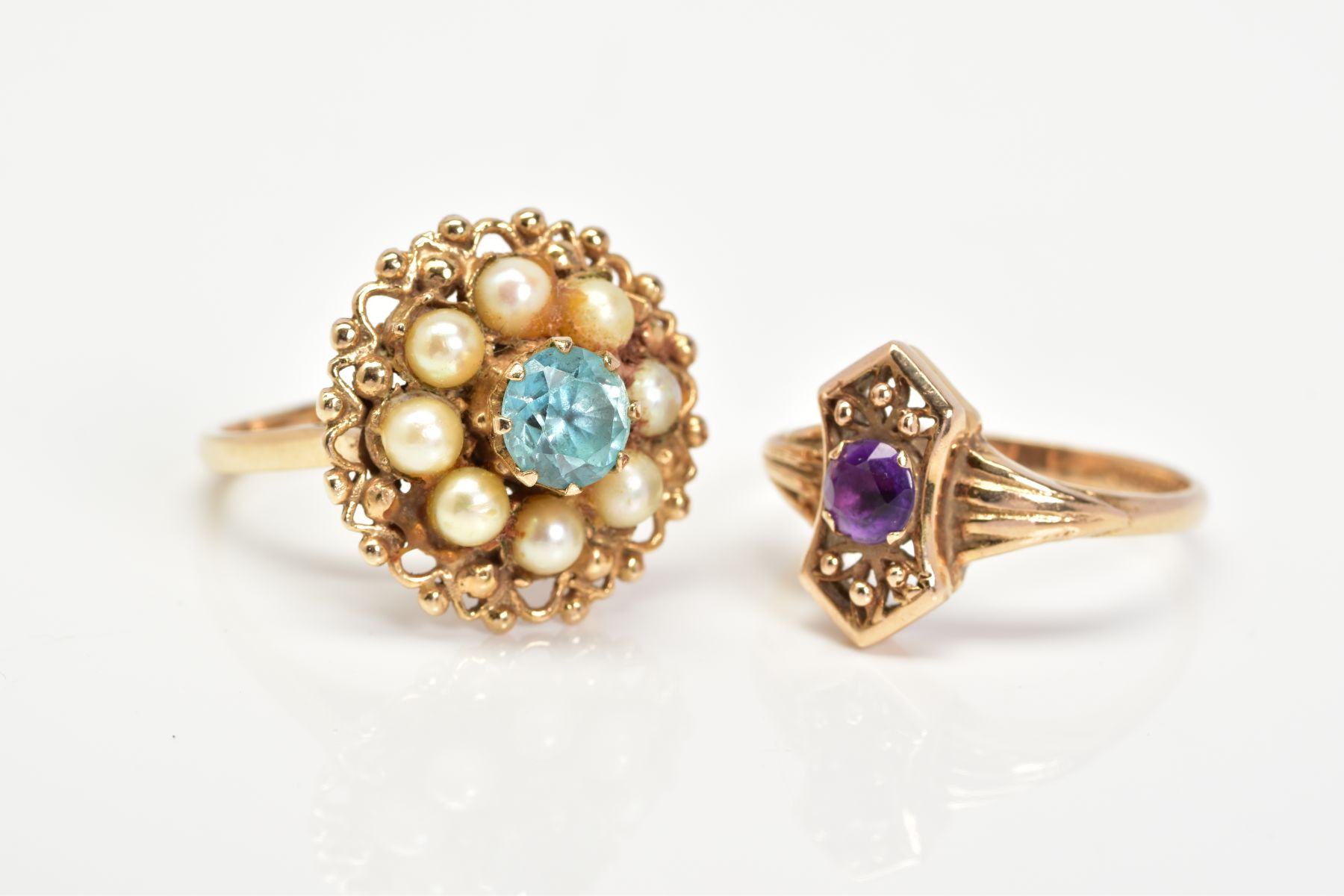 TWO 9CT GOLD GEM SET RINGS, the first of cluster design set with a central circular blue stone