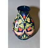 A MOORCROFT POTTERY BALUSTER VASE IN THE STRAWBERRY THIEF PATTERN, on a dark blue ground, circa