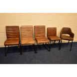 A SET OF THREE BROWN LEATHER DINING CHAIRS on sleigh metal legs, together with another similar