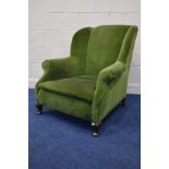 A GEORGIAN STYLE GREEN UPHOLSTERED WING BACK ARMCHAIR