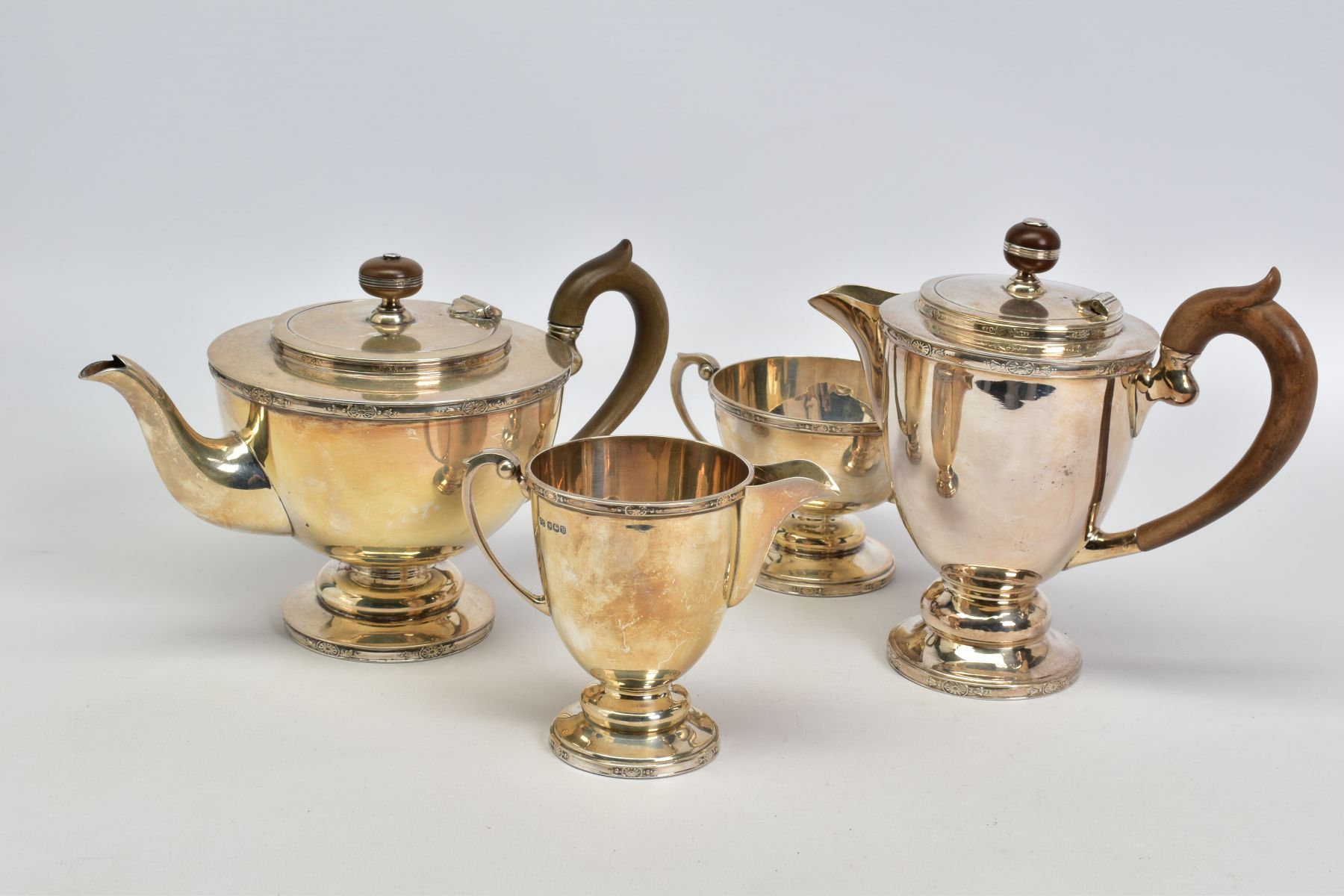 A MATCHED GEORGE V AND ELIZABETH II SILVER FOUR PIECE TEA SERVICE OF CIRCULAR FORM, cast rims with - Image 5 of 6