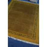 A MID TO LATE 20TH CENTURY OCHRE GROUND RUG, 295cm X 247cm