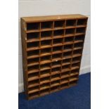 A WOODEN PIGEON HOLE UNIT, made up of twenty five shelves, width 85cm x depth 20cm x height 112cm