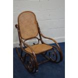 A BENTWOOD ROCKING CHAIR, after design Thonet with a cane work seat and back, 50cm wide x 92cm high
