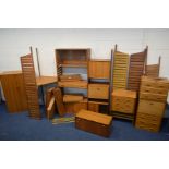 A STAPLES LADDERAX TEAK TEN BAY MODULAR SHELVING SYSTEM, comprising eleven tall wall mounted teak