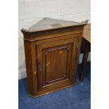 A REPRODUCTION CARVED OAK TWO DOOR CORNER CUPBOARD, width 65cm x depth 36cm x height 97cm