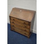 AN EARLY TO MID 20TH CENTURY OAK BUREAU, with a fitted interior and four exterior drawers, on