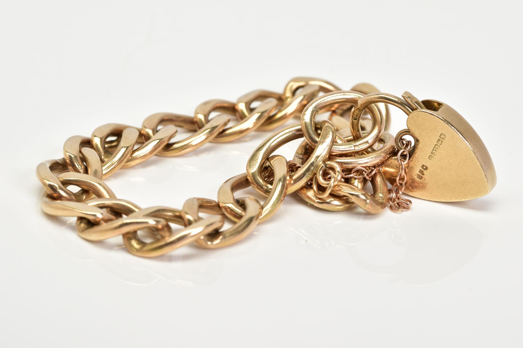 A 9CT GOLD CHARM BRACELET, of curb link design with each link stamped 3.975, to a heart clasp with a - Image 2 of 2