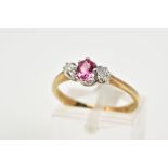 A 9CT GOLD TOURMALINE AND DIAMOND RING, designed with a central oval claw set pink tourmaline