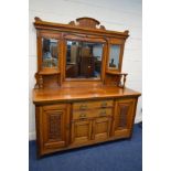 AN EARLY 20TH CENTURY GOLDEN OAK MIRROR BACK SIDEBOARD, the top with triple bevelled mirrors,