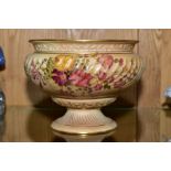 A ROYAL WORCESTER BLUSH IVORY PEDESTAL BOWL, with wrythern moulded body florally decorated, shape No