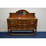 AN EARLY TO MID 20TH CENTURY SIDEBOARD, with a shaped back with a bevelled mirror, double