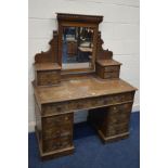 A DISTRESSED EARLY 20TH CENTURY CARVED OAK PEDESTAL DRESSING TABLE, with a single mirror, and twelve