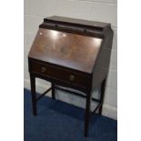 AN EDWARDIAN MAHOGANY BUREAU, the top with a slopped reeding comprising two drawers, the fall