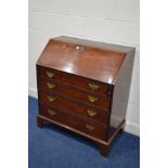 A GEORGIAN MAHOGANY BUREAU, the fall front revealing a fitted interior, above four exterior drawers,