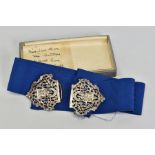 A LATE VICTORIAN SILVER NURSE'S BUCKLE MOUNTED ON A WIDE FABRIC BELT, the buckle pierced and