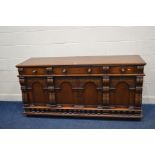 A REPRODUCTION CARVED OAK SIDEBOARD, two short drawers flanking one long drawer above four arched