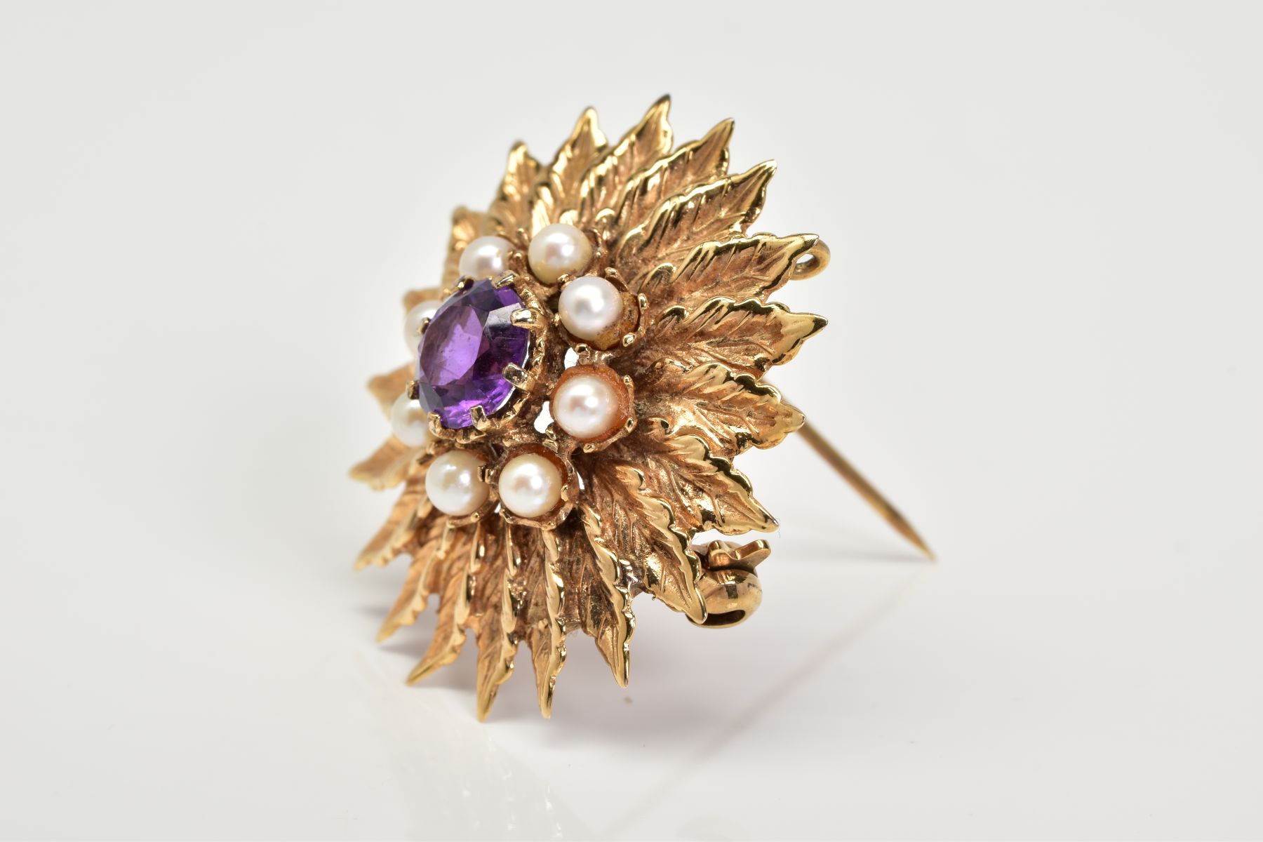 A 9CT GOLD AMETHYST AND PEARL BROOCH, of floral design set with a central circular cut amethyst - Image 2 of 3