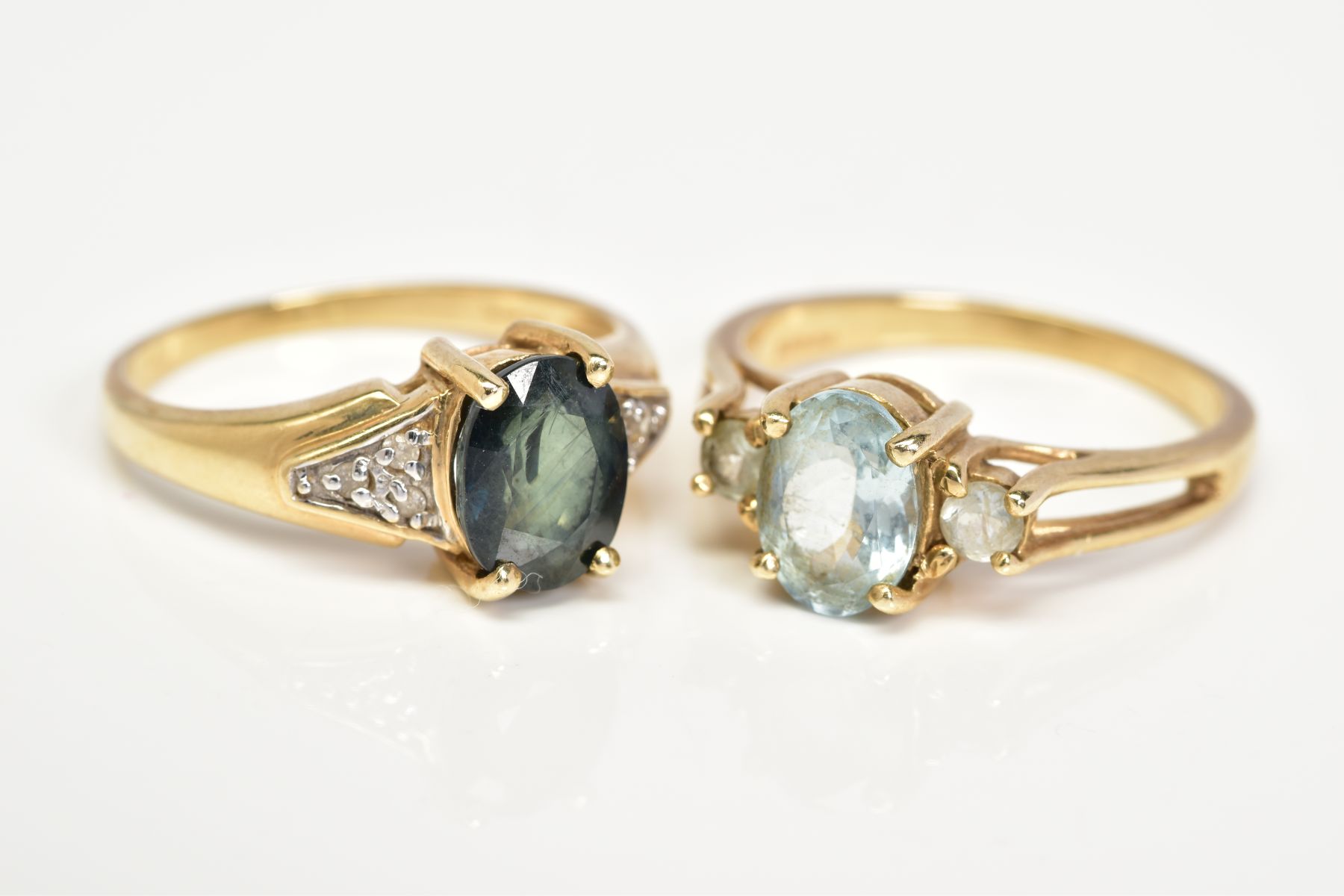 TWO 9CT GOLD GEM SET RINGS, the first designed with a claw set oval cut sapphire, to the single