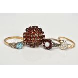 FOUR GEM SET RINGS, the first a yellow metal ring designed with a central circular cut topaz to