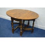 A REPRODUCTION ELM OVAL TOPPED GATE LEG TABLE, on turned and block legs united stretchers, open