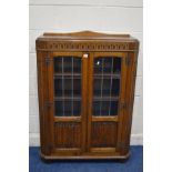 AN EARLY TO MID 20TH CENTURY OAK LEAD GLAZED AND LINENFOLD TWO DOOR BOOKCASE, width 92cm x depth