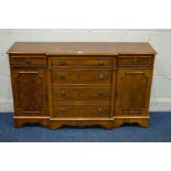 A REPRODUCTION YEWWOOD BREAKFRONT SIDEBOARD with three drawers above three cupboard doors, width