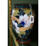 A DOULTON AND SLATERS PATENT LAMBETH STONEWARE BALUSTER VASE, glazed with pink and blue poppies over