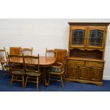 A GERMAN GOLDEN OAK DINING SUITE, comprising an extending dining table, with two additional