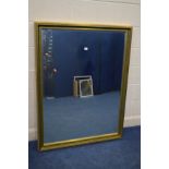 A LARGE MODERN GILT FRAMED BEVELLED EDGE WALL MIRROR, 101cm x 131cm