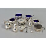 A GROUP OF SILVER CRUETS, including an Edwardian oval three piece set, pierced sides, comprising