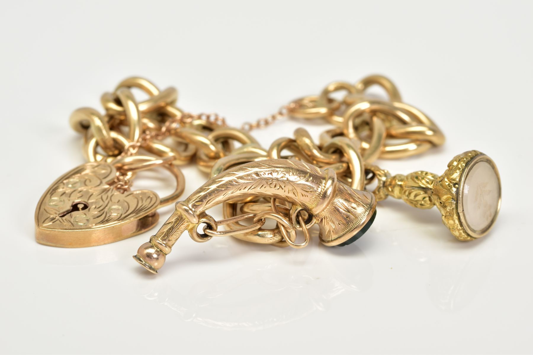A 9CT GOLD CHARM BRACELET, the charm bracelet which suspends two charms, the first a fob seal - Image 3 of 4