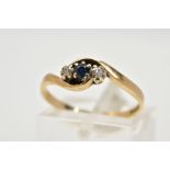 A 9CT GOLD SAPPHIRE AND DIAMOND RING, of crossover design set with a central circular cut sapphire