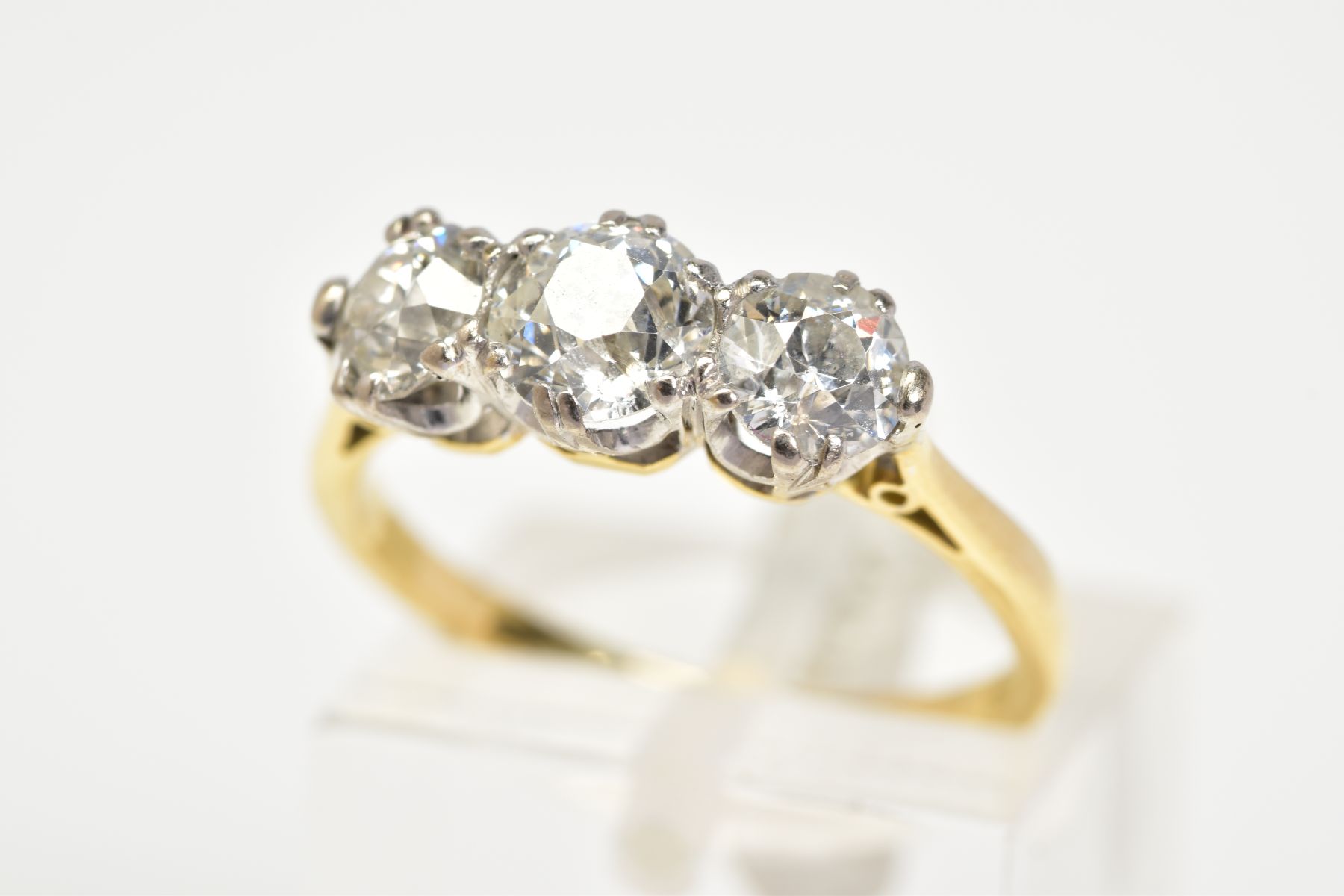 A NEARLY TO MID 20TH CENTURY THREE STONE DIAMOND RING, three transitional cut diamonds, measuring