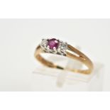 A 9CT GOLD THREE STONE RING, designed with a central claw set circular cut ruby flanked by round