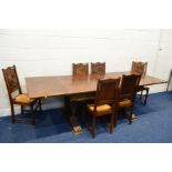 AN EARLY 20TH CENTURY OAK DRAW LEAF BRETON TABLE, raised on four standing figures united by