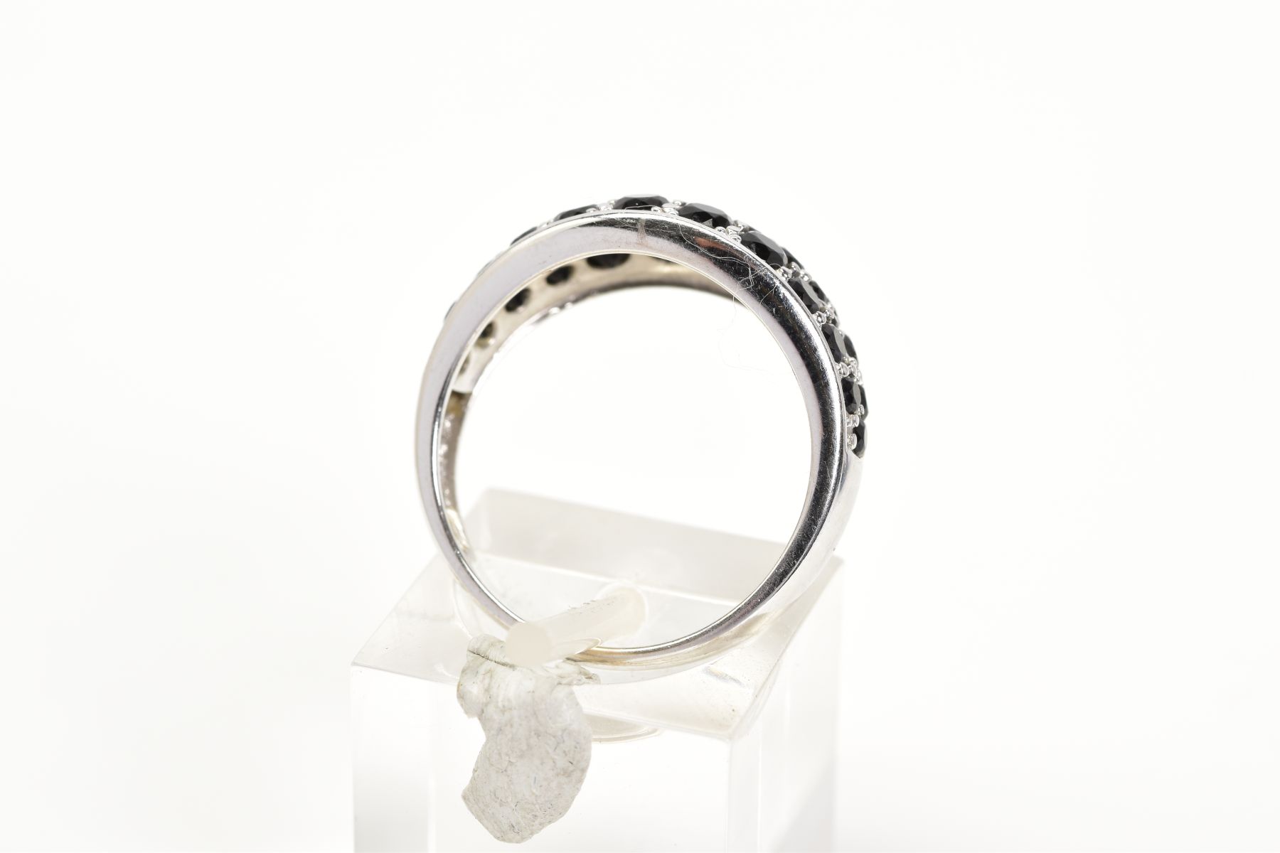 A GEM SET RING, the white metal ring designed with an oval panel set with circular cut black - Image 3 of 3