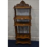 A WALNUT SERPENTINE FIVE TIER WHAT NOT, width 49cm x depth 28cm x height 131cm (loose top)