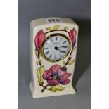 A MOORCROFT POTTERY QUARTZ MANTEL CLOCK, pink magnolia design on a cream ground, impressed and