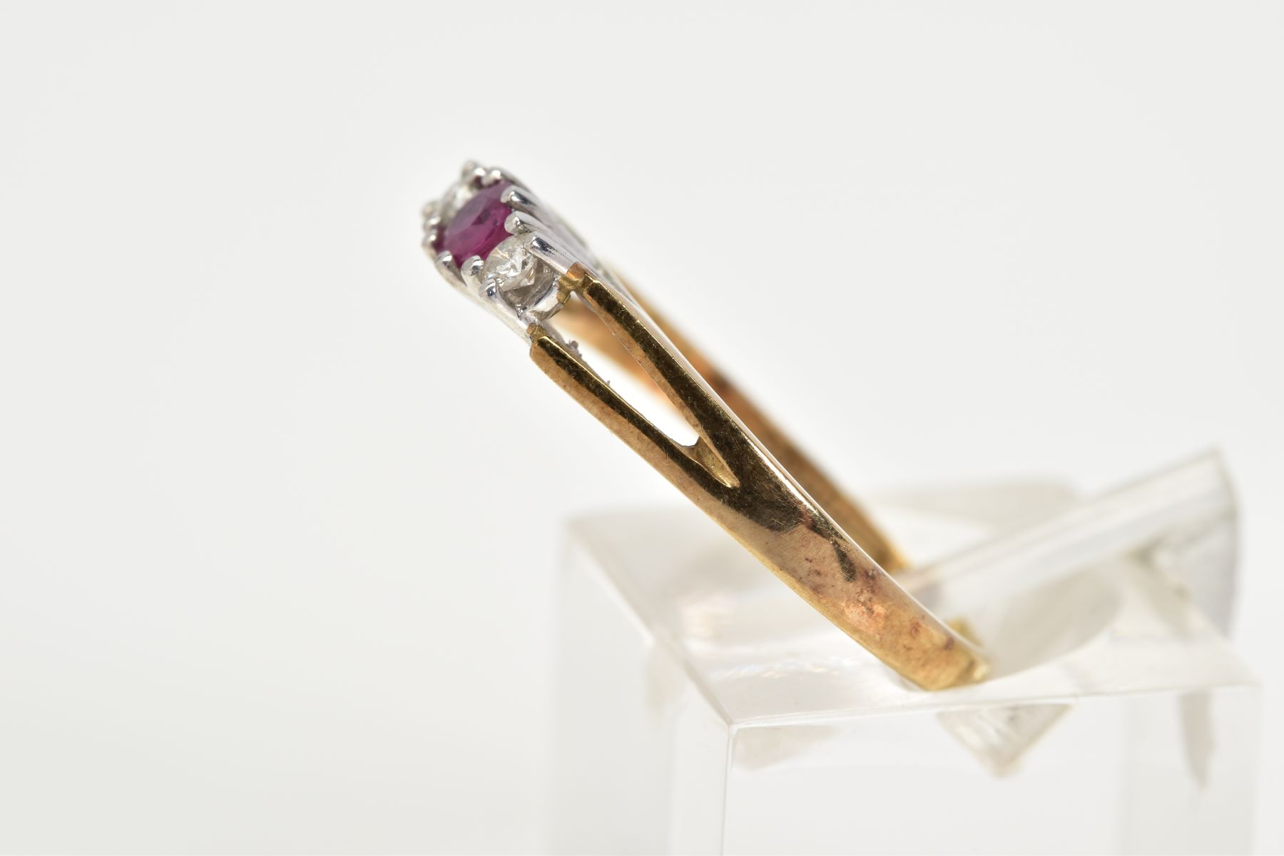 A 9CT GOLD THREE STONE RING, designed with a central claw set circular cut ruby flanked by round - Image 2 of 3