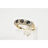 A 9CT GOLD SAPPHIRE AND DIAMOND HALF HOOP RING, set with three circular cut sapphires, interspaced